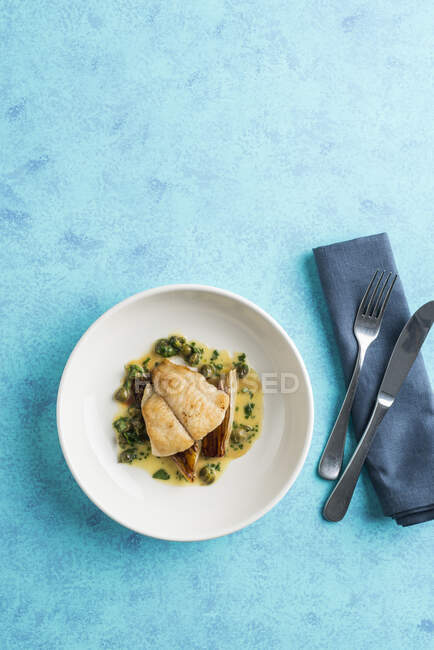 Close-up shot of delicious Fried fish with a caper sauce — Stock Photo