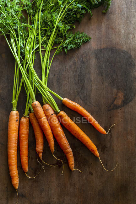 Zanahorias frescas sobre fondo de madera - foto de stock
