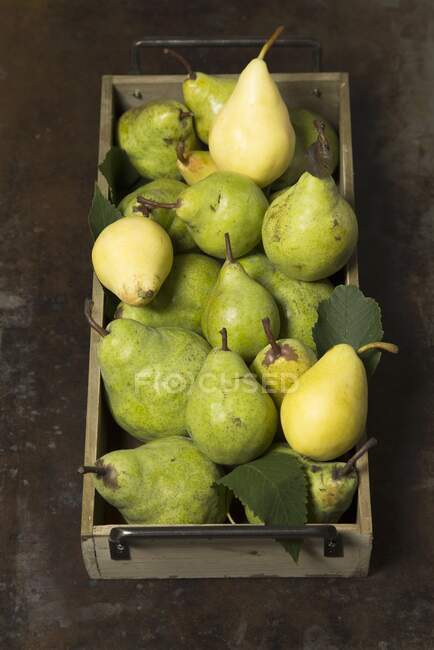 Pears in a wooden crate — Stock Photo