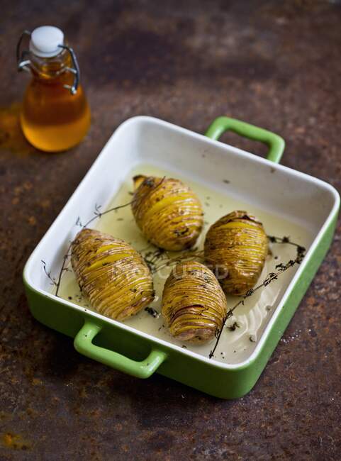 Hasselback potatoes with thyme — Stock Photo