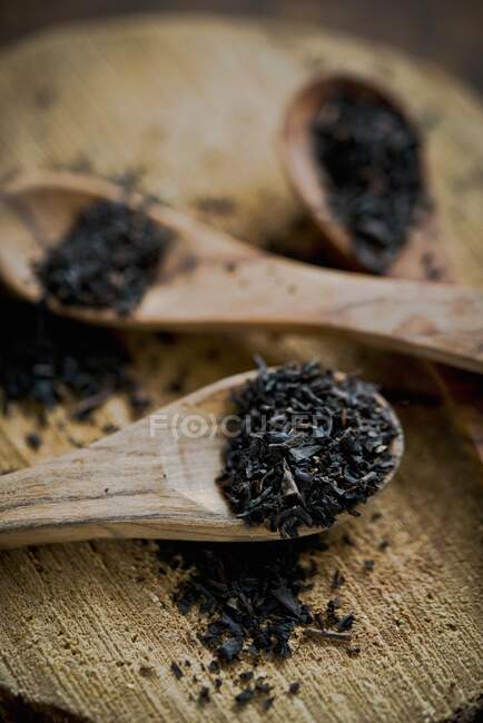 Earl Grey tea leaves on wooden spoons — Stock Photo