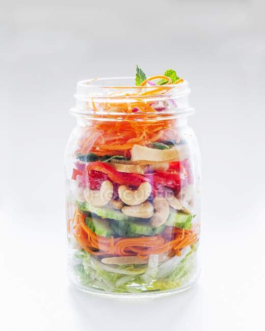 Vegetable salad with cashew nuts in a glass jar — Stock Photo