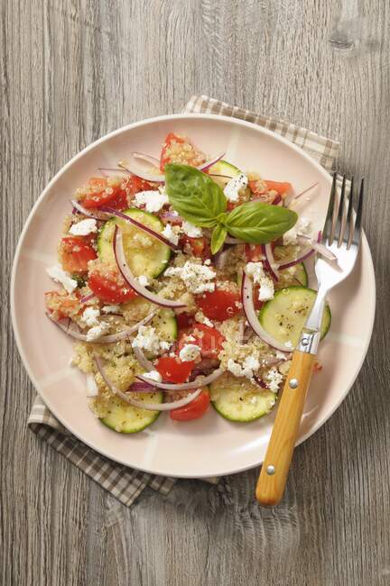 Salada de quinoa com abobrinhas, tomate, cebola e queijo fresco — Fotografia de Stock