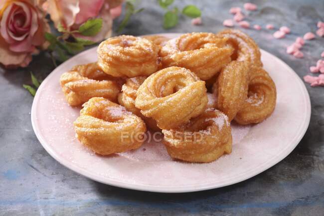 Churros with sugar on a pink plate — Stock Photo