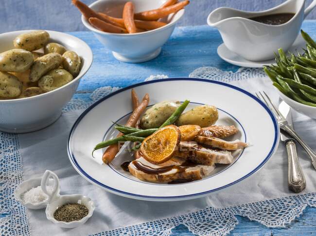 Turkey with carrots, beans and potatoes on plate — Stock Photo