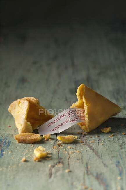 Fortune cookie, broken on wood — Stock Photo