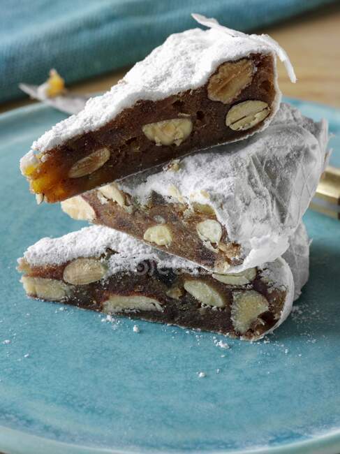 A pile of Panforte slices on a plate — Stock Photo