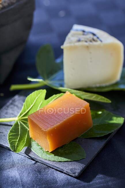 Quince jelly and a piece of Tomme de Brebis cheese — Stock Photo