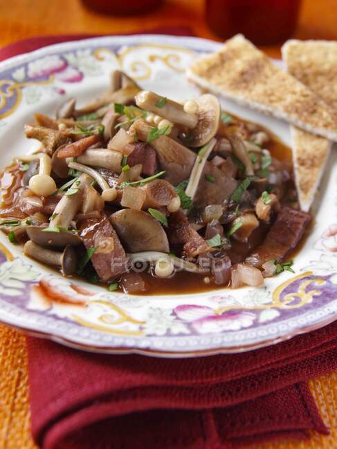 Close-up shot of delicious plate of mushroom ragout in a table setting — Stock Photo