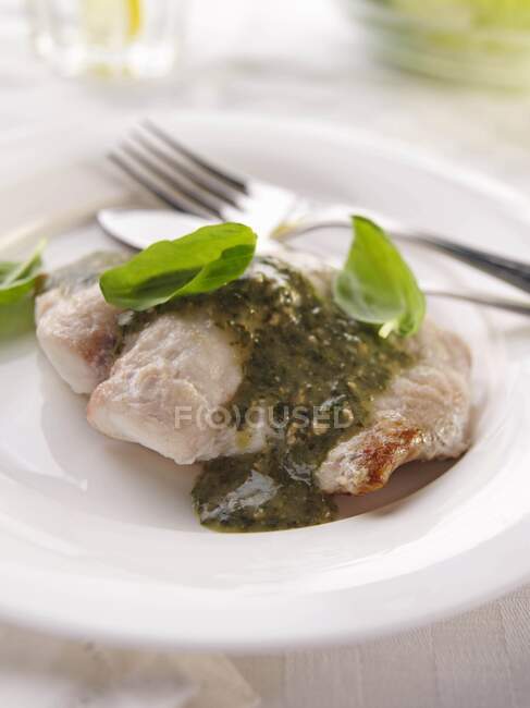 Single serving of pesto fish with herbs — Stock Photo
