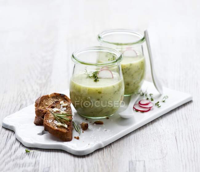 Herb and potato soup in glasses — Stock Photo