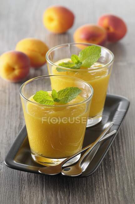 Apricot gazpacho with mint leaves — Stock Photo