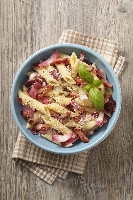 Penne with bacon and radicchio — Stock Photo