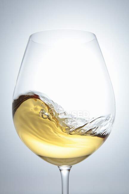 White wine in a glass with a wave — Stock Photo