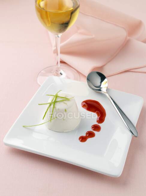 Lime and coconut panna cotta with raspberry coulis lactose and gluten free dessert — Stock Photo