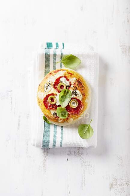 Mini pizza with green olives and salami — Stock Photo