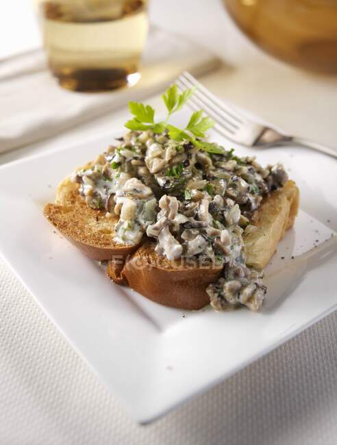 Close-up shot of delicious plate of Duxelles mushrooms in a table setting — Stock Photo