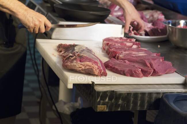 Steaks being cut close-up view — Stock Photo