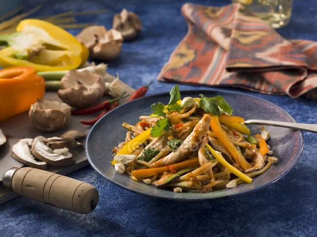 Asian chicken pasta with cutlery — Stock Photo