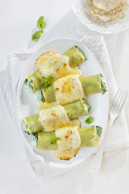 Stuffed cannelloni with Bechamel sauce melted over the top — Stock Photo