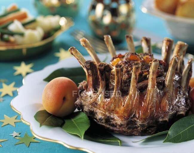 A crown roast in a festive table setting — Stock Photo