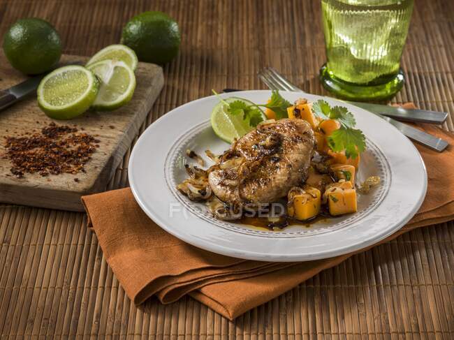 Lime glazed pork cutlets with pumpkin and limes — Stock Photo