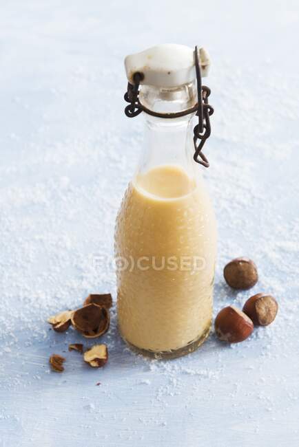 Homemade nut liqueur in a bottle — Stock Photo