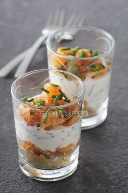 Savoury layered hors d'oeuvres with two types of salmon and chives — Stock Photo