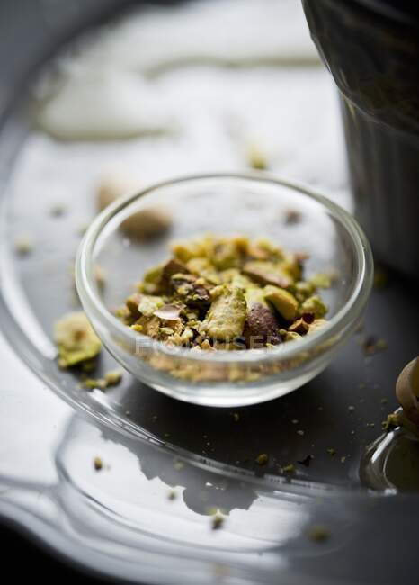 Chopped pistachios in a glass bowl — Stock Photo