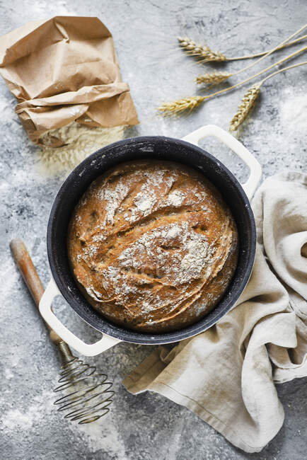 Homemade wheat bread in a cast iron pot — Stock Photo
