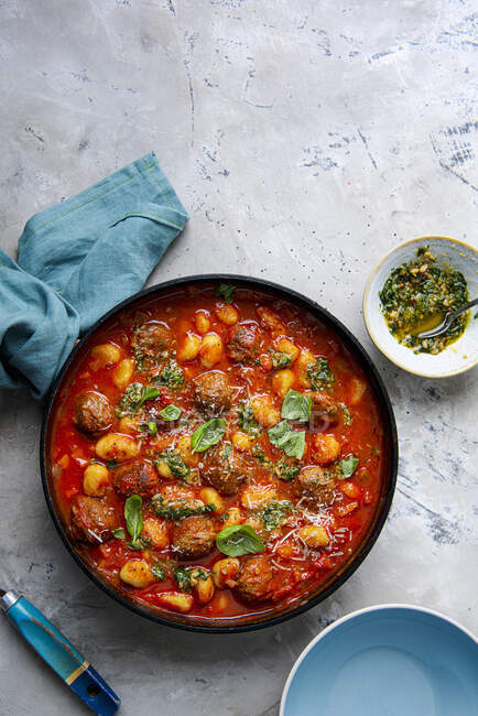 Tomato soup with meatballs and gnocchi with basil pesto — Stock Photo