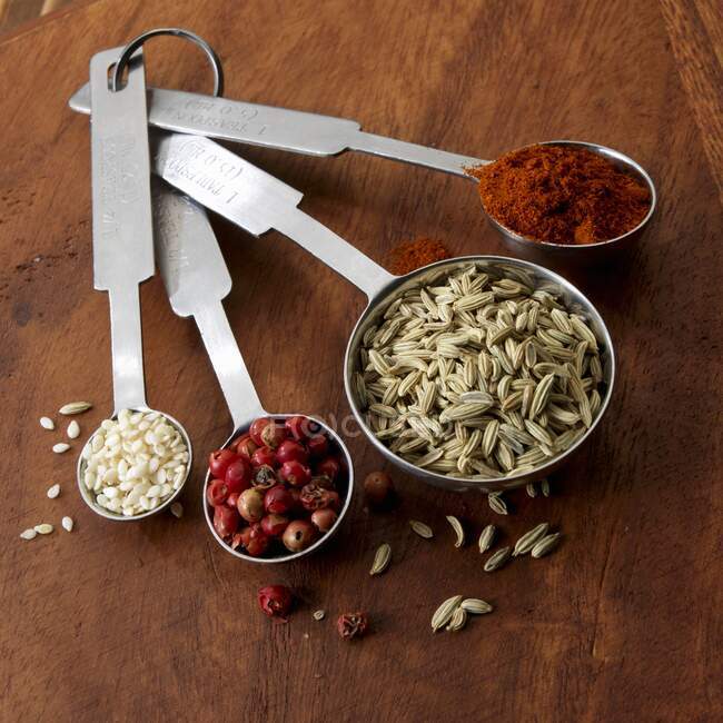 Spices and sesame in measuring spoons — Stock Photo