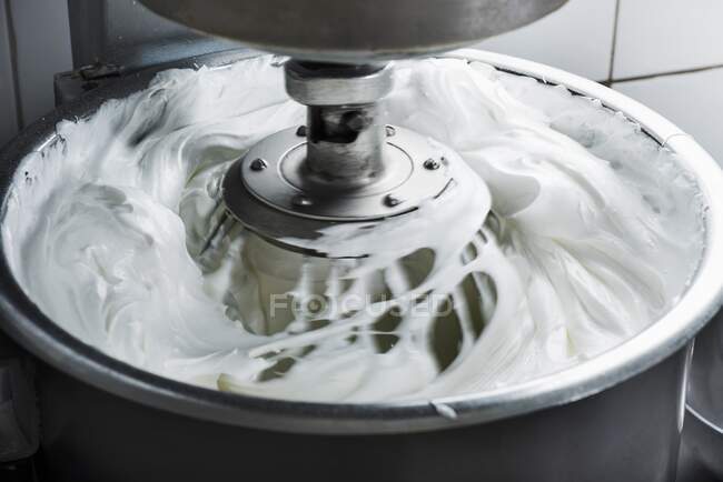 Egg whites being whipped in a mixer — Stock Photo