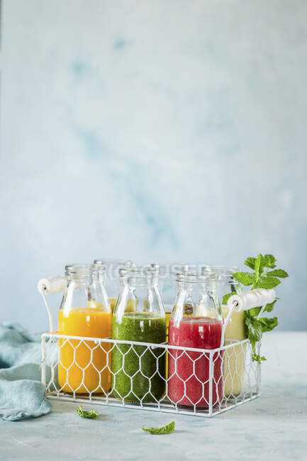Various smoothies in a drinks holder — Stock Photo