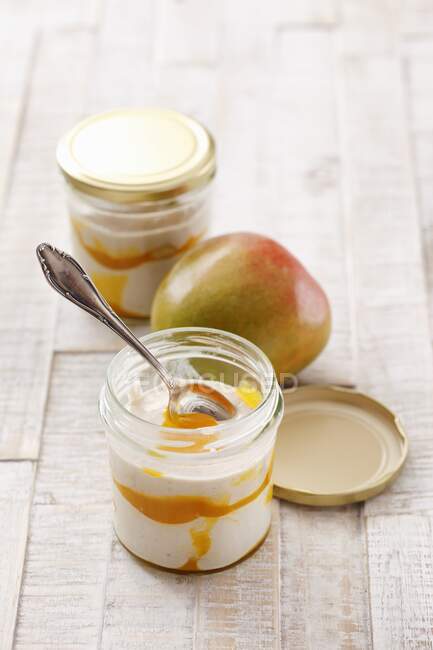 Quark and mango layered dessert in glass — Stock Photo