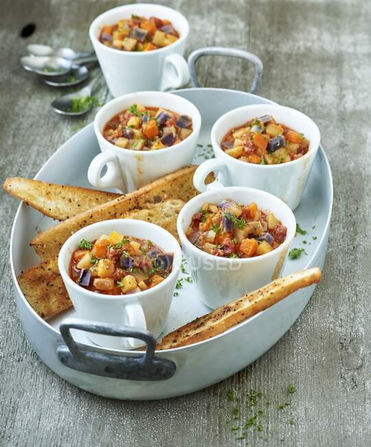 Colorful cardboard pot with chorizo ??and spicy toast — Stock Photo