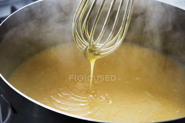 Lemon curd being stirred with a whisk — Stock Photo