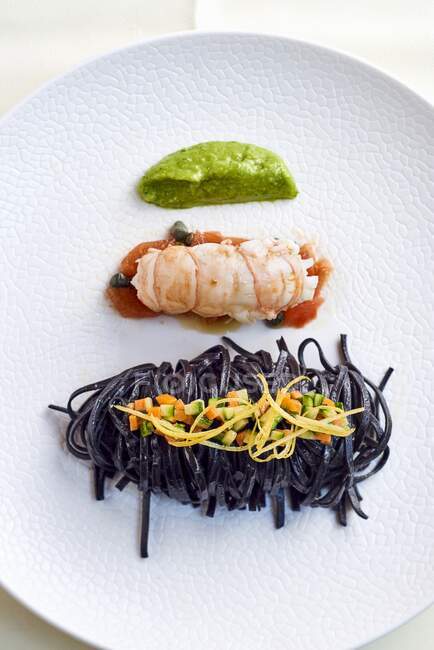 Black tagliolini with Norway lobster — Stock Photo