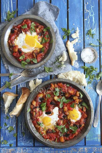 Shakshuka (poached eggs in tomato sauce) with white bread — Stock Photo