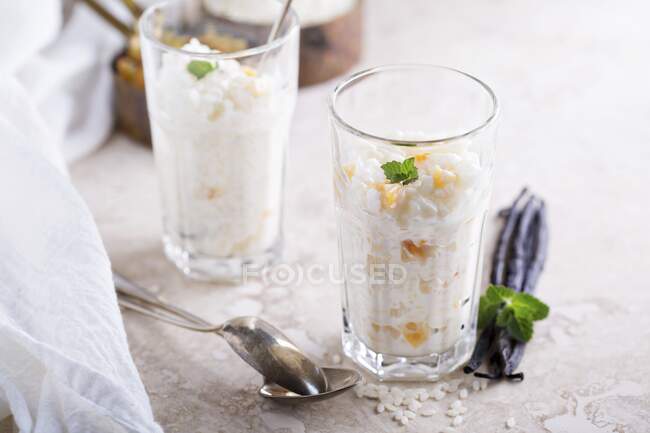 Rice pudding with dried apricots in tall glass — Stock Photo