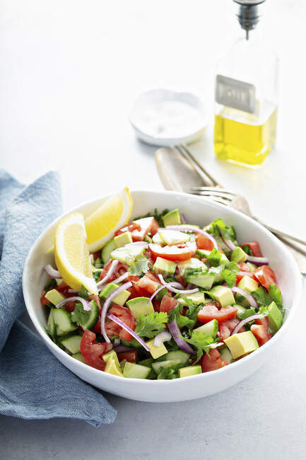 Fresh vegetables chopped salad with tomato, cucumber and avocado — Stock Photo