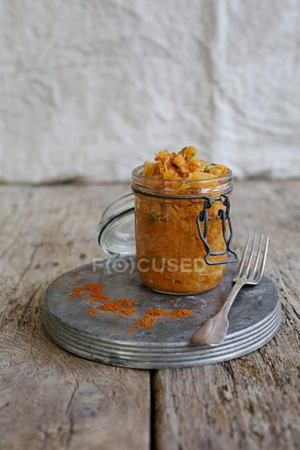 Sauerkraut with peppers in a glass jar — Stock Photo