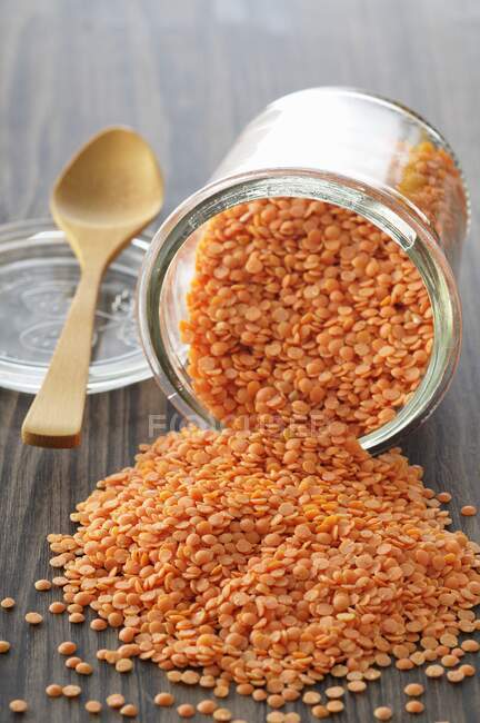 An upset glass of red lentils — Stock Photo