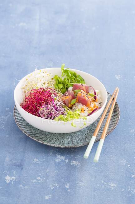 Poke bowl with sprouts and tuna with chopsticks on plate — Stock Photo