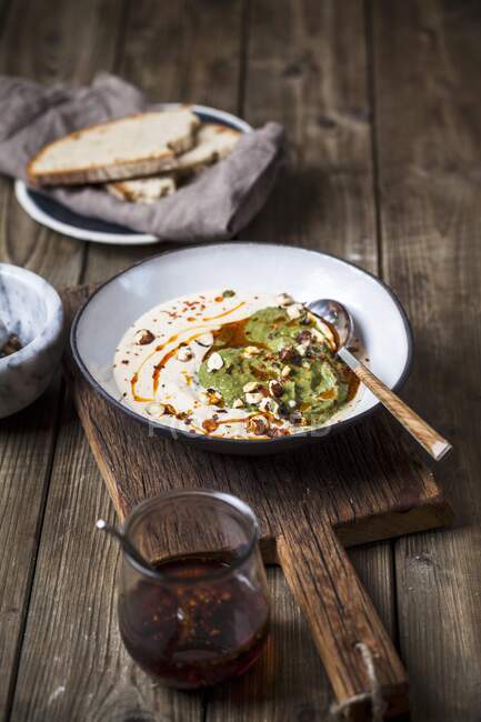 Холодный белый чесночный суп с грецкими орехами, шпинат и соус чили — стоковое фото