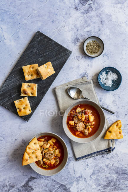 Homemade minestrone soup with Italian sausage and focaccia — Stock Photo