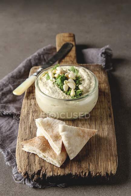 Classic hummus with herbs, olive oil in glass jar and lavash, Traditional Middle Eastern cuisine — Stock Photo