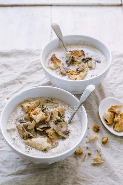 Mushroom soup served with croutons in small bowls — Stock Photo