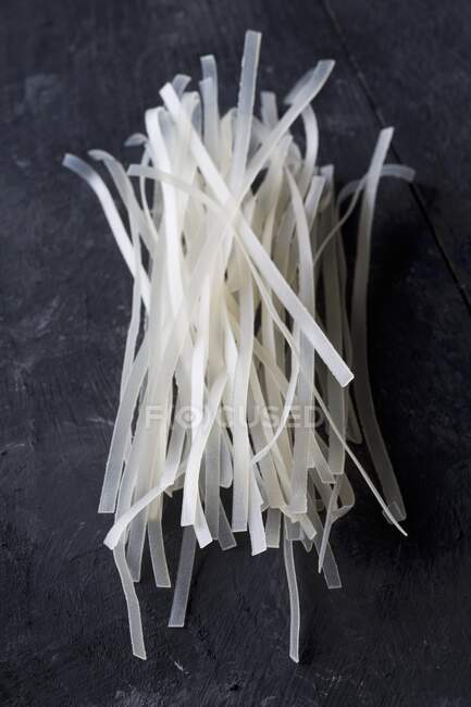 Dried glass noodles on a black background — Stock Photo