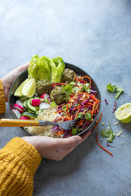Vegeterian Buddha bowl with lime and slaw, spinach falafels, couscous and salad — Stock Photo